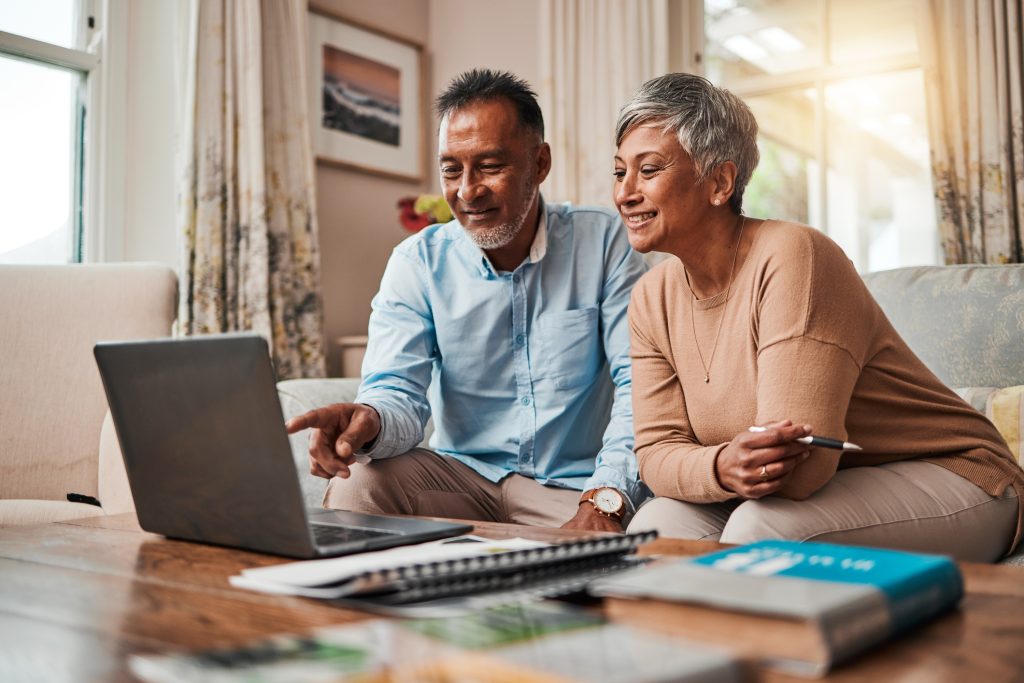 Couple reviewing retirement income planning on a laptop